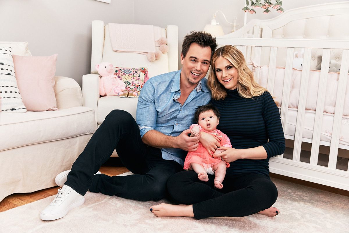 Soap stars Darin Brooks and Kelly Kruger in a nursery with their newborn baby.