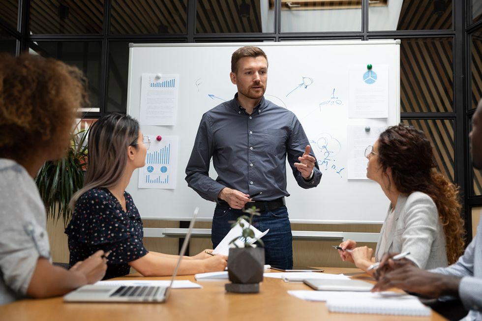 Business manager holds a team meeting to discuss changes in the workplace.