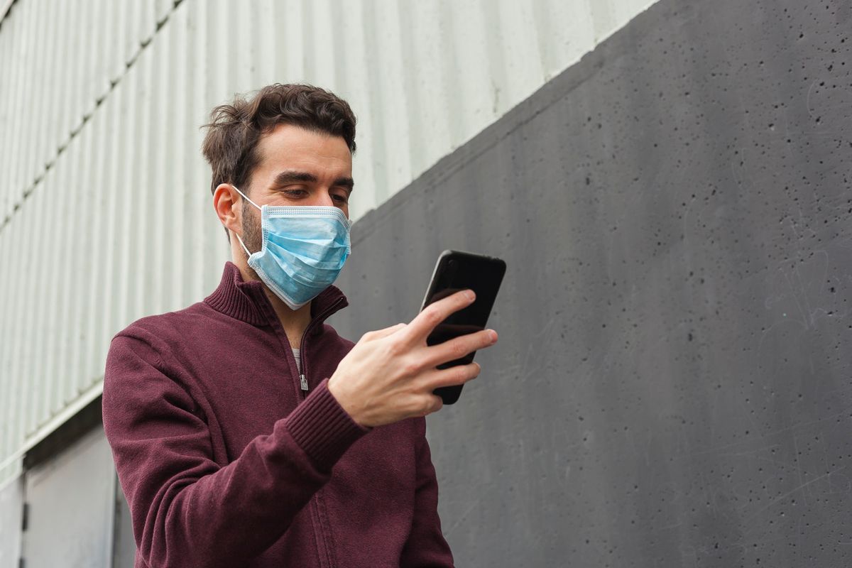 Smartphone user with a mask