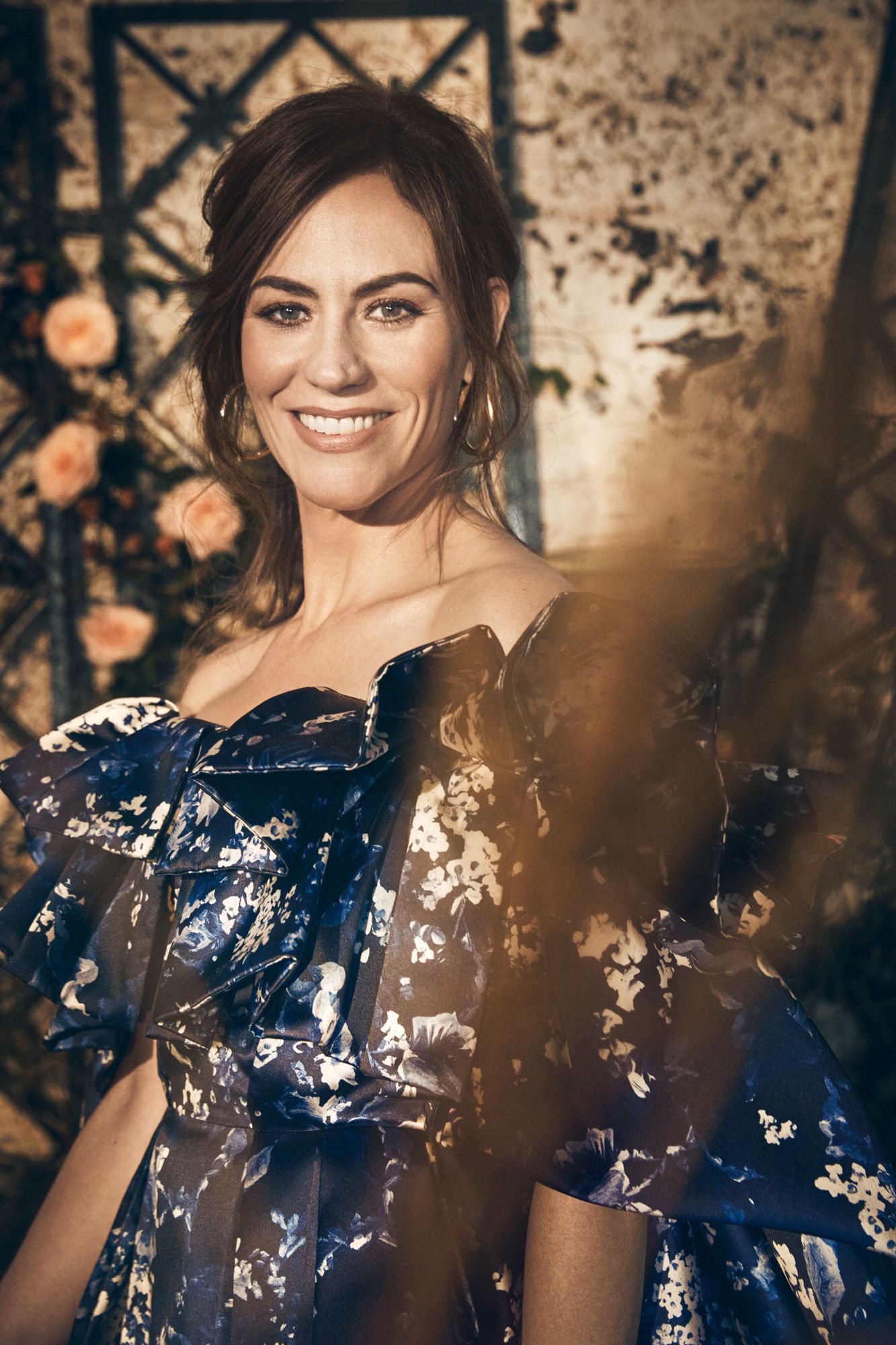 Maggie Siff in a royal blue gown embellished with a floral pattern.
