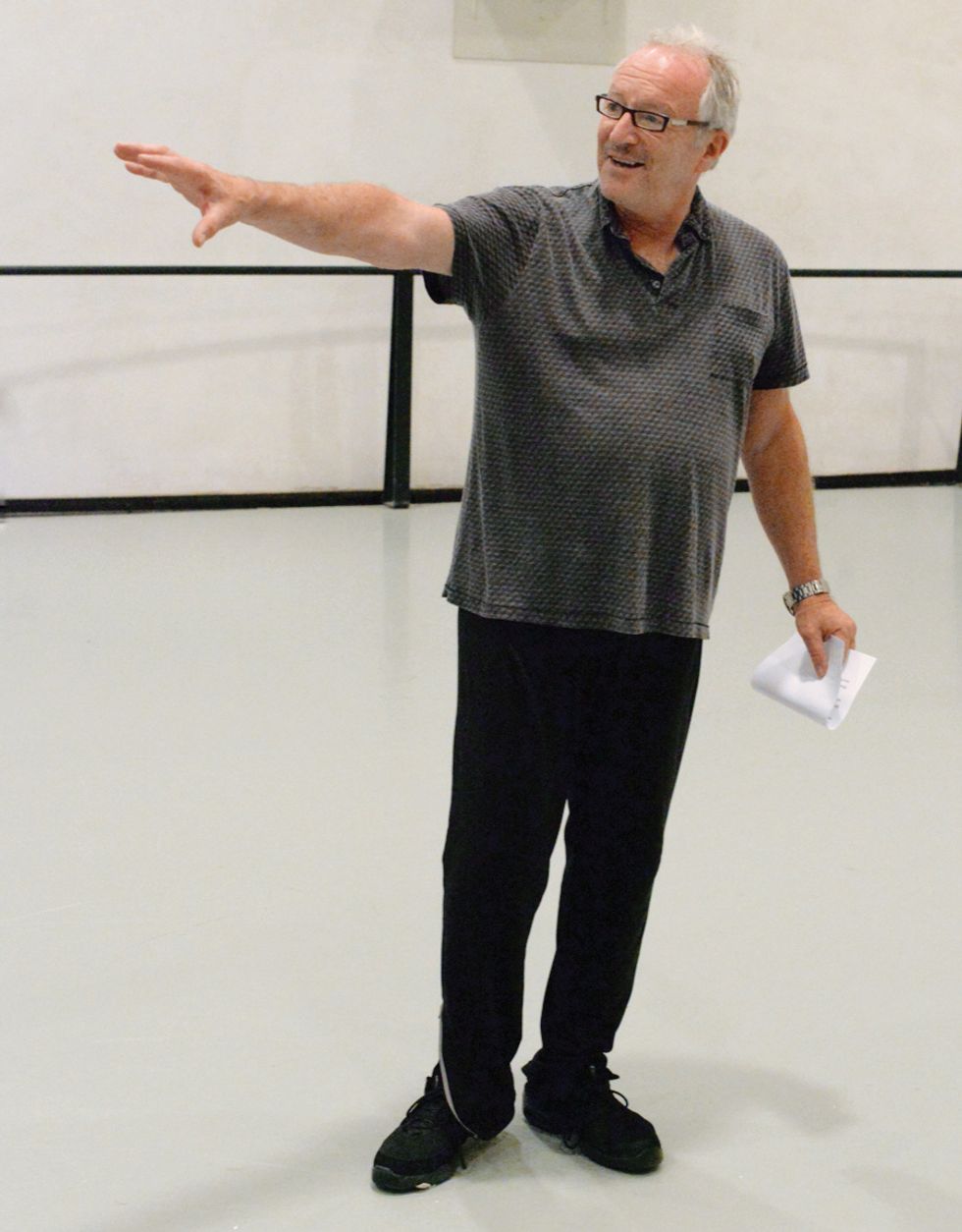 Vernon stands in a studio, gesturing with his left hand.