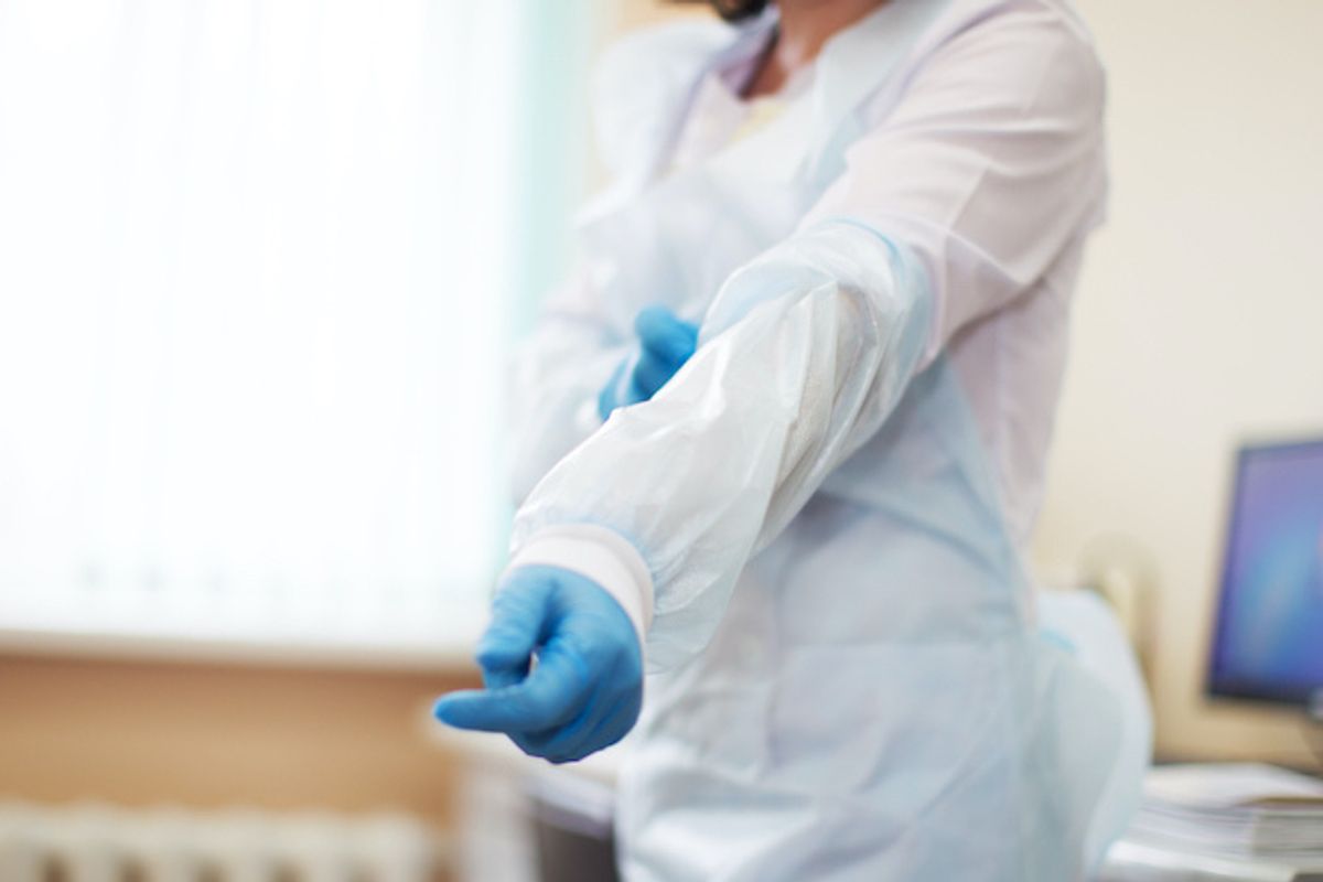 Medical staff putting on PPE