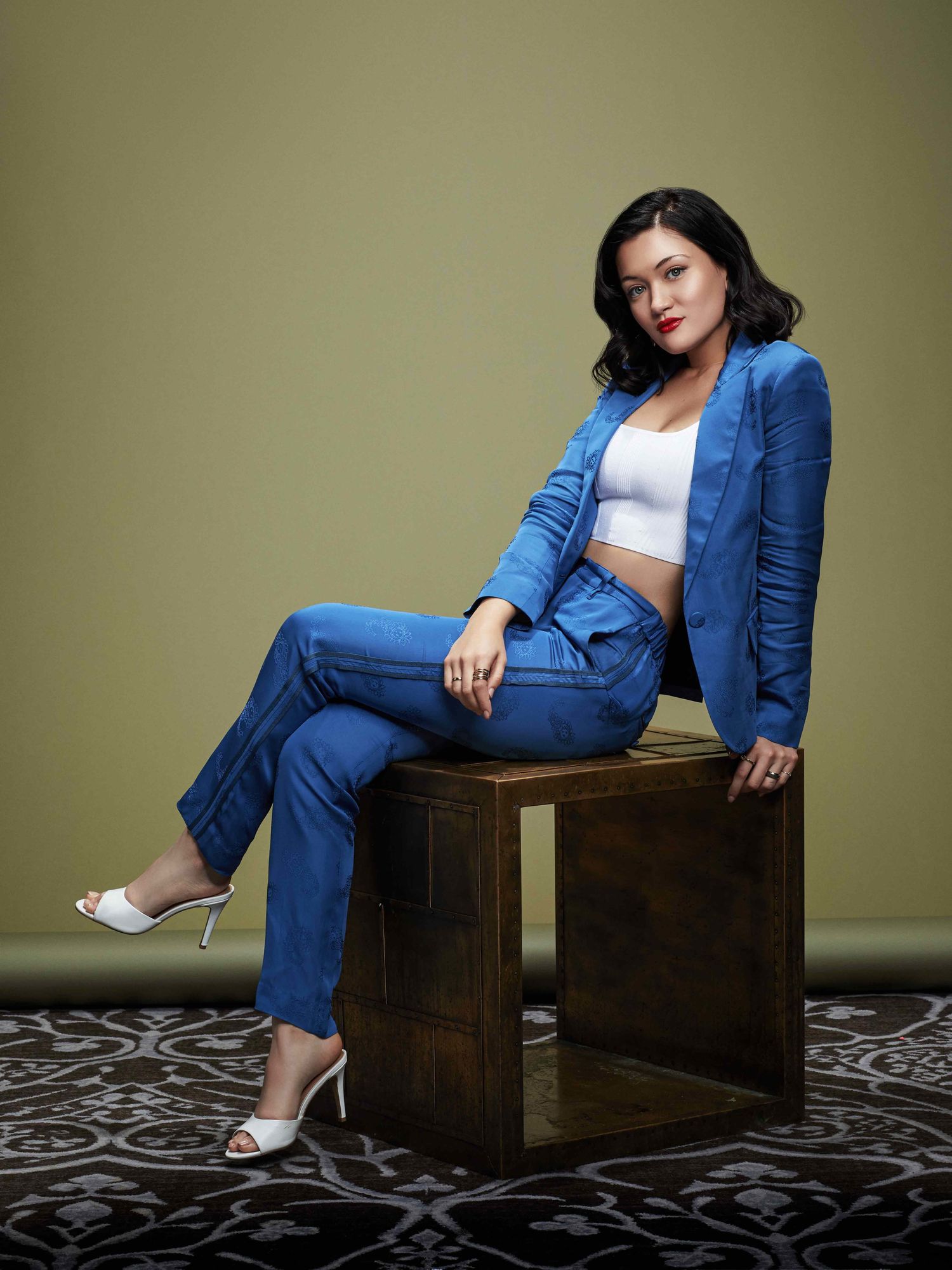 Actress Isa Briones reclines in blue silk jacket and pants.