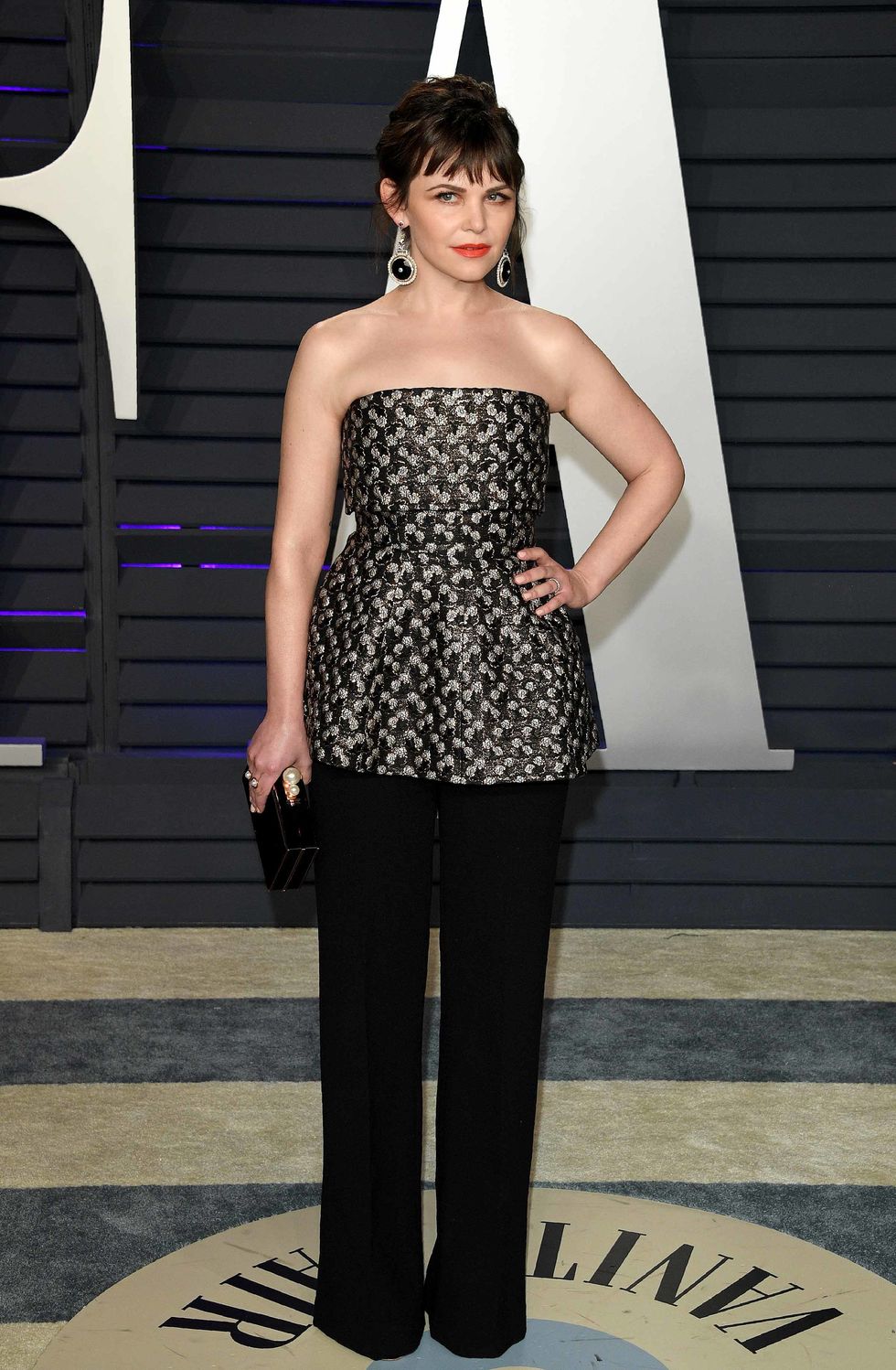 Ginnifer Goodwin in a strapless top and black pants.