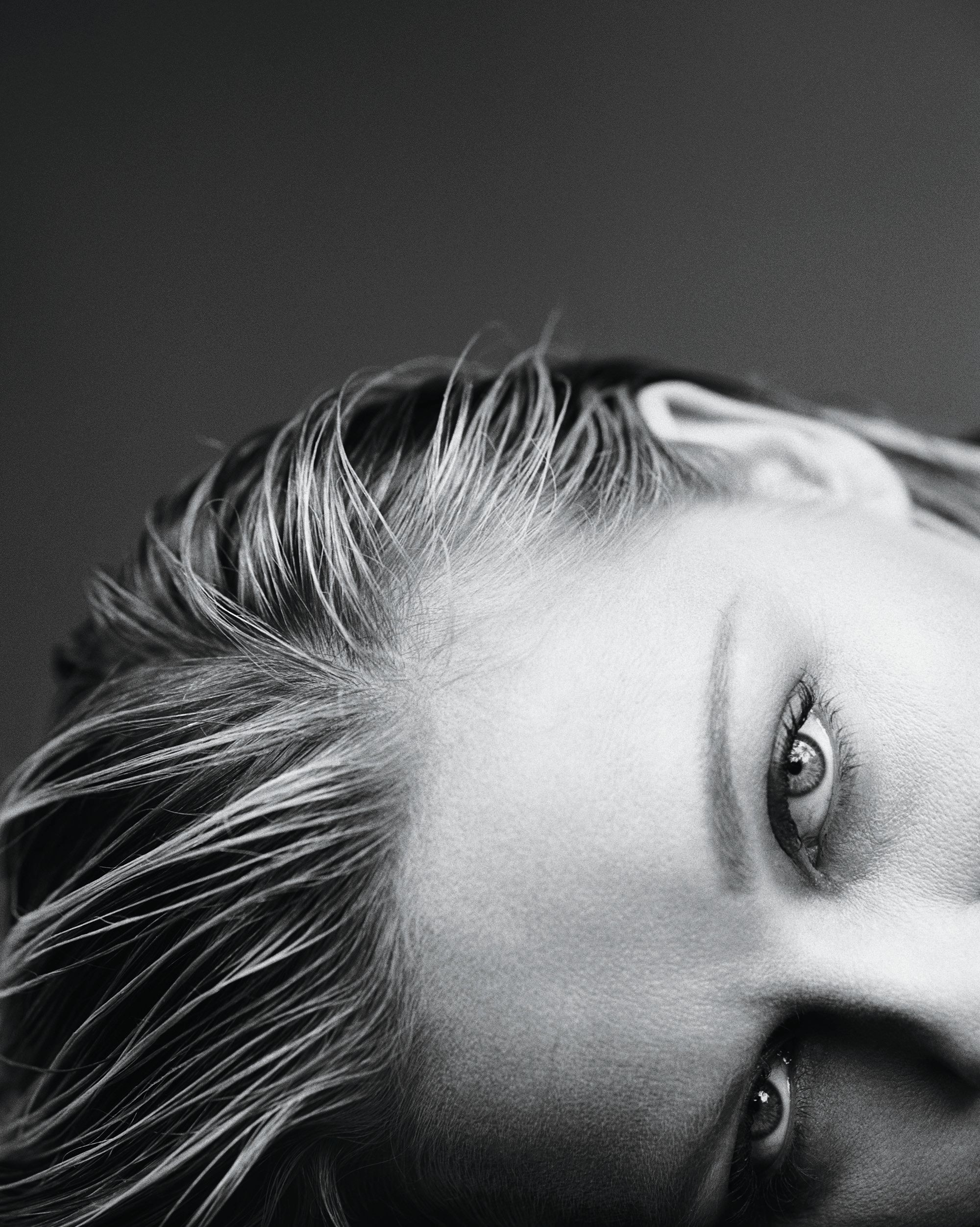 A closeup black and white photo of Kirsten Dunst's eyes.