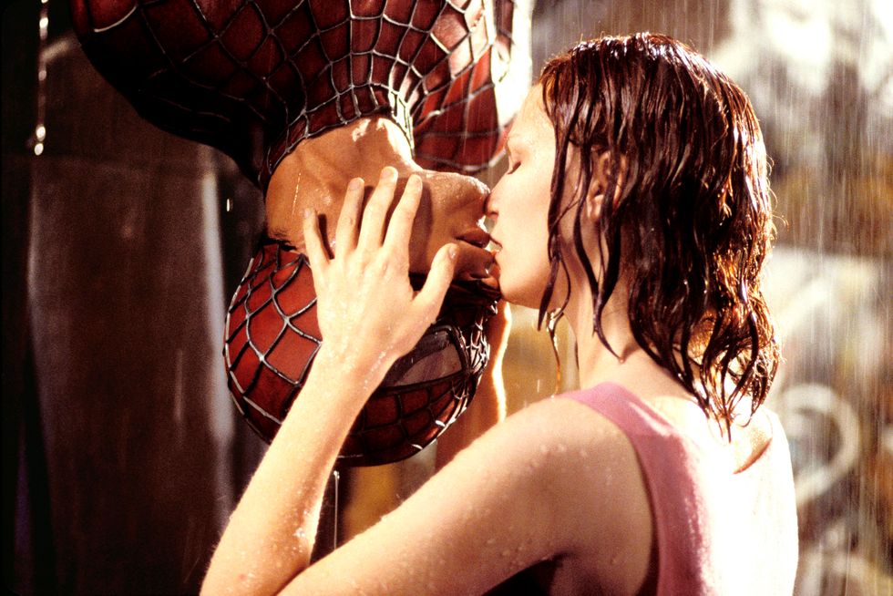 Kirsten Dunst kisses an upside down Spider-Man in the rain.