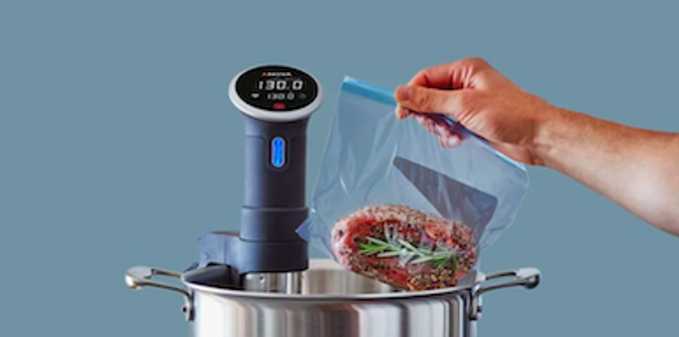 A photo of Anova Precision Cooker in a pot cooking a lobster.