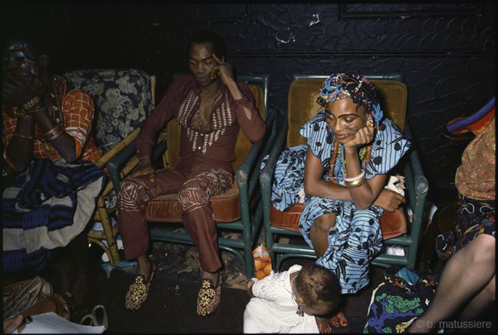 Fela Kuti sits with the Kalakuta Queens.