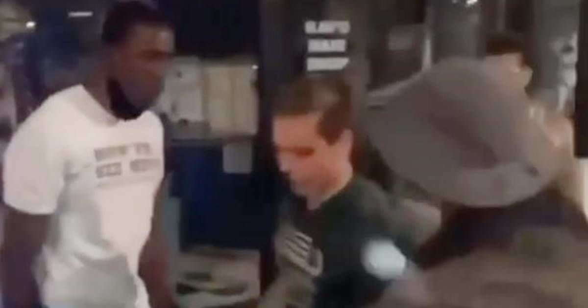 Group of black peacemakers stop a rioting white teen from breaking a window with his skateboard