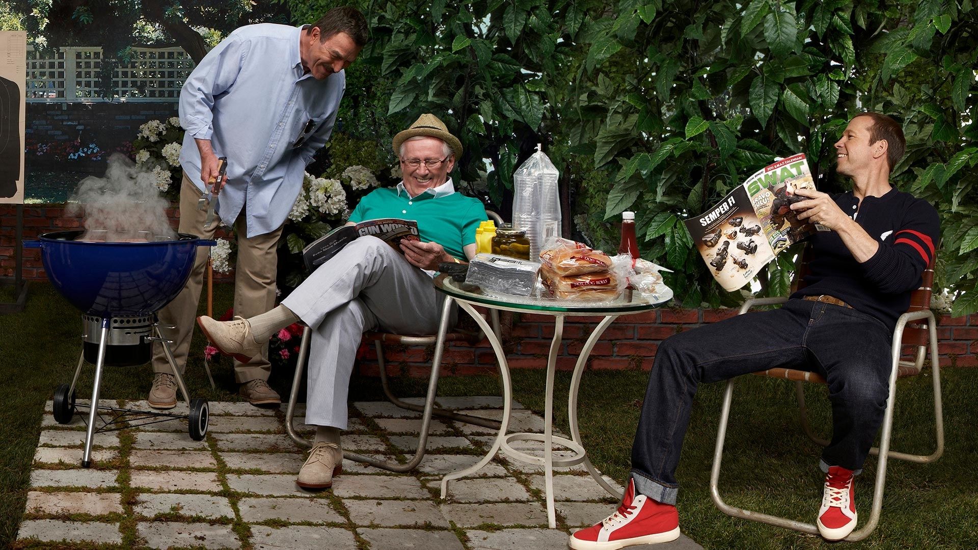Tom Selleck cooking on the grill with Len Cariou and Donnie Wahlberg.