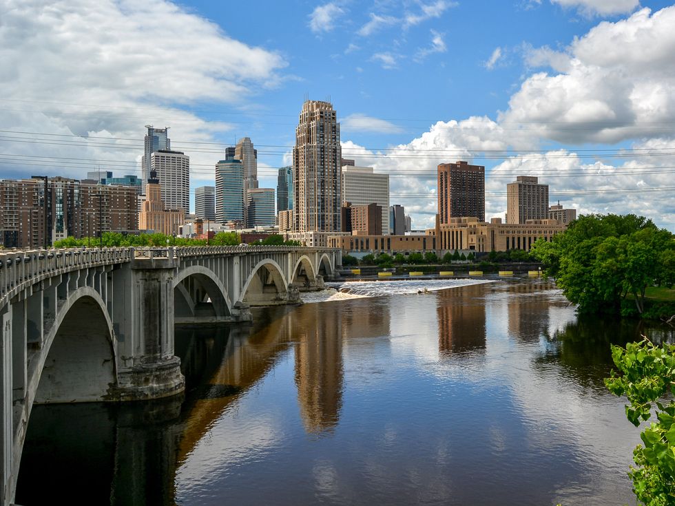 Arch Bridge Over River By Buildings Against Sky Minneapolis Minnesota