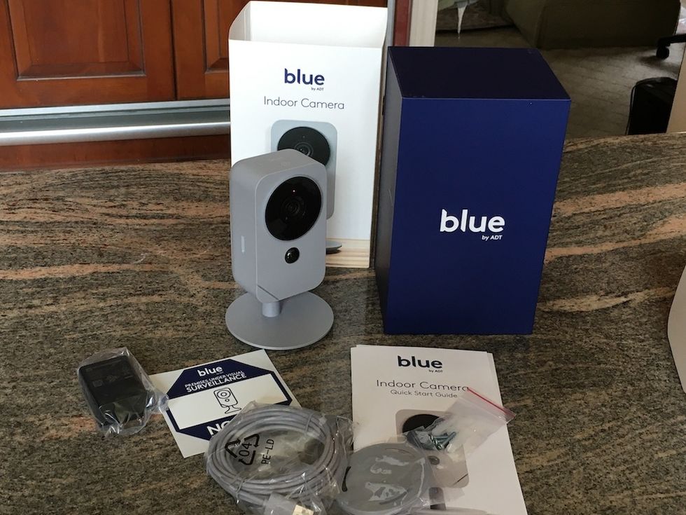 blue by adt indoor camera unboxed on a counter.