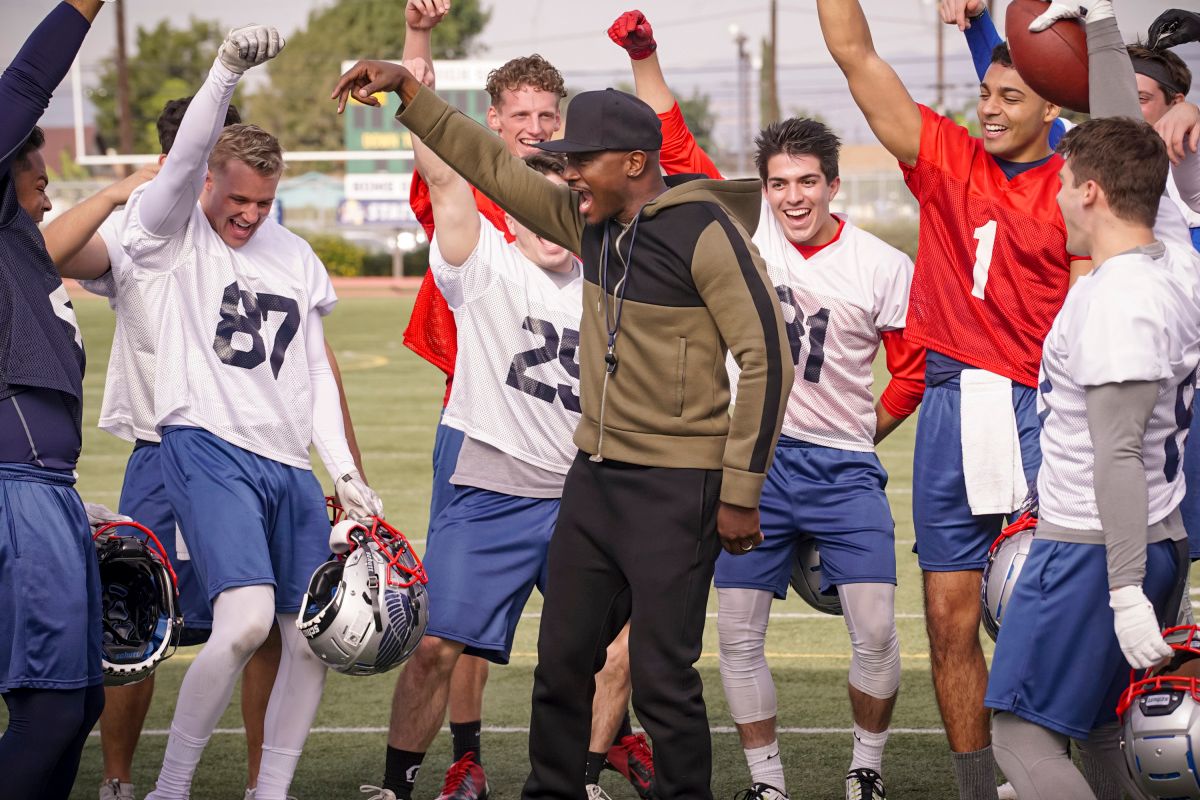 High school football players with Taye Diggs on TV show from The CW All American