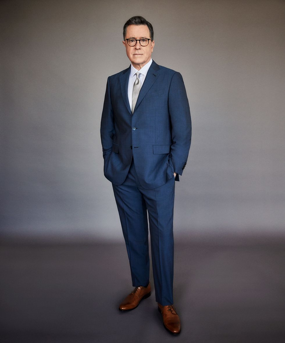 Stephen Colbert in a navy blue suit.