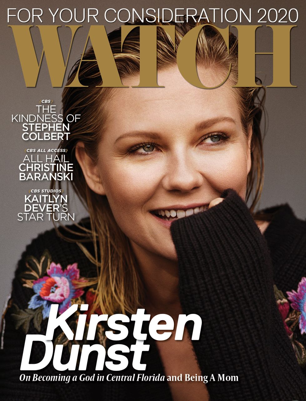 Kirsten Dunst smiling on the cover of a magazine.