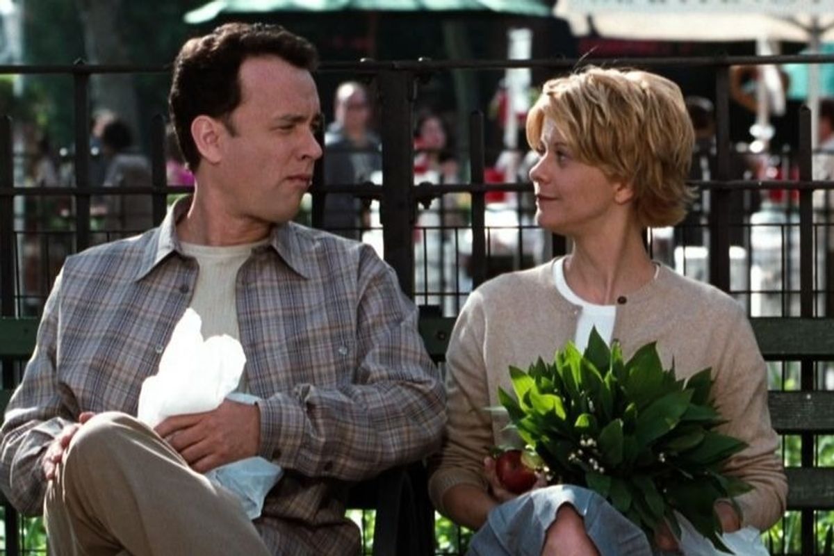 Tom Hanks and Meg Ryan sitting on a park bench in the film You've Got Mail