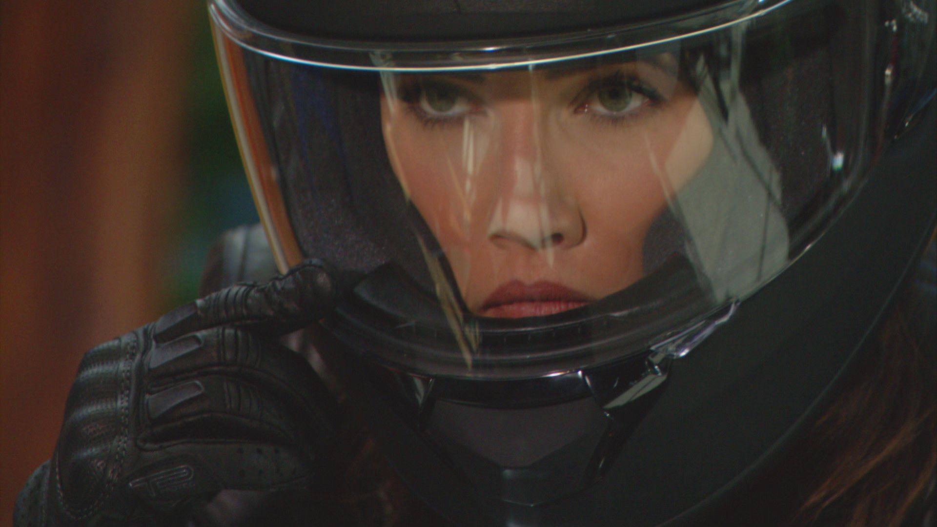 \u200bJacqueline MacInnes Wood as Steffy adjusts her black motorcycle helmet