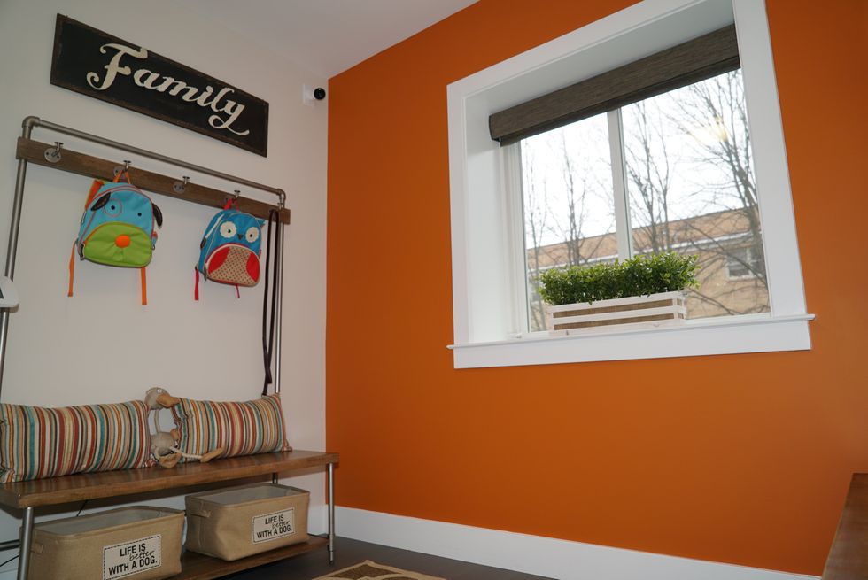 Photo of foyer of Alarm.com Demo House with cameras, window sensors and more smart devices.