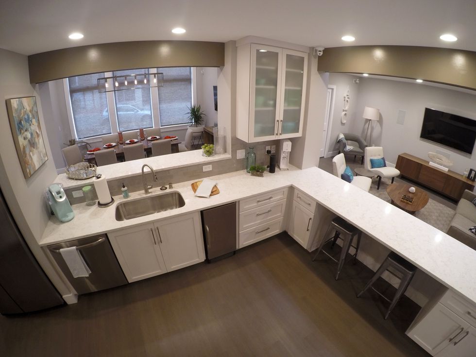Photo of Alarm.com demo house kitchen and entertainment rooms which have devices users can control in Alarm.com app
