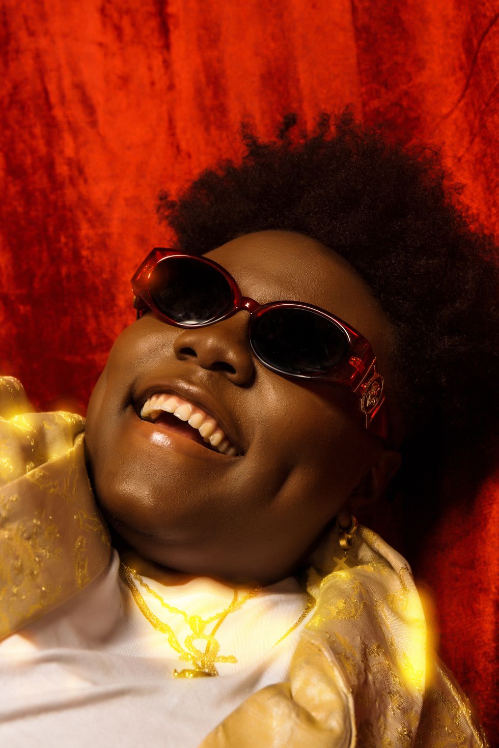 Teni smiles in a close-up portrait shot.