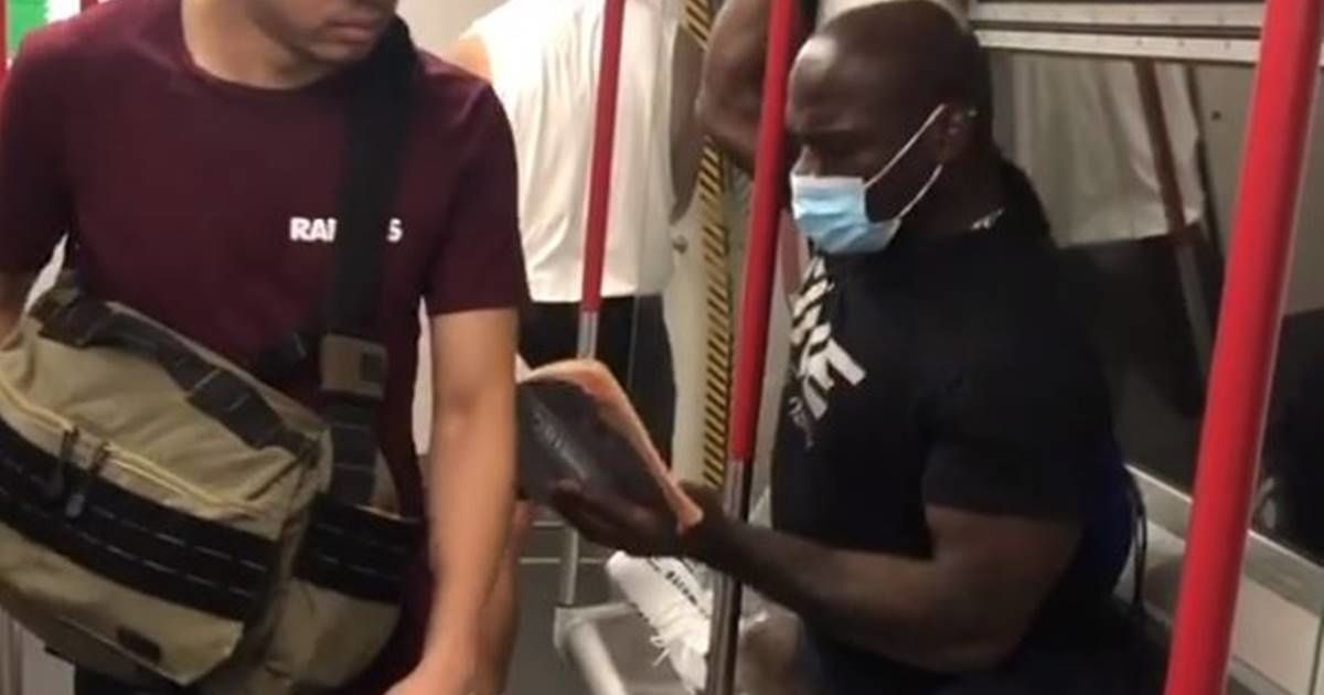 Incredibly flexible MMA fighter performs the splits to avoid sitting next to maskless rider