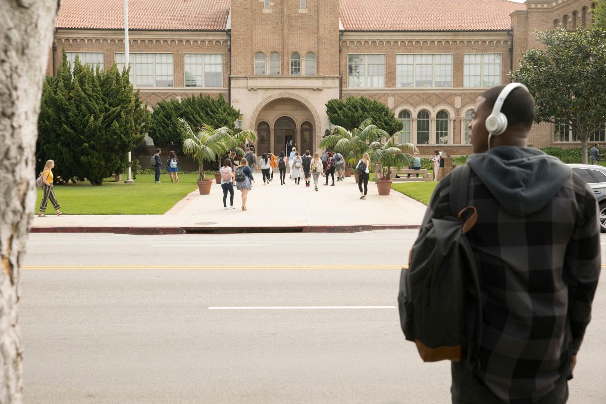 Daniela Ezra in front of a prestigious high school on TV show from The CW All American