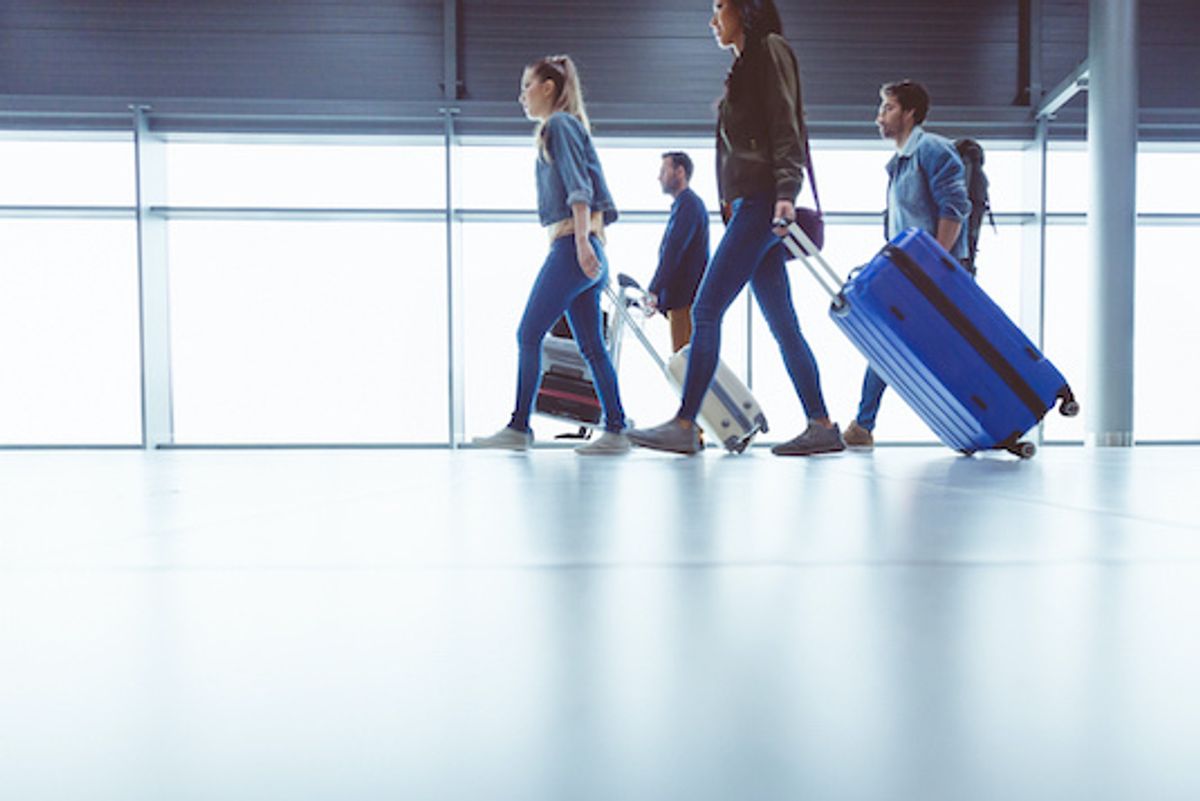 People walking in an airport with luggage