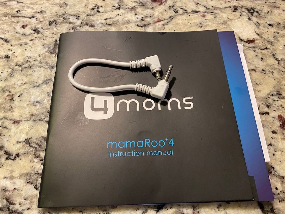 mamaRoo4 mp3 cord and instruction manual on a counter.  Cord is short.