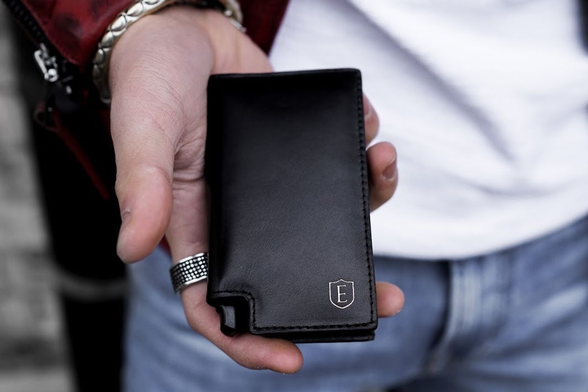 man holding ekster wallet