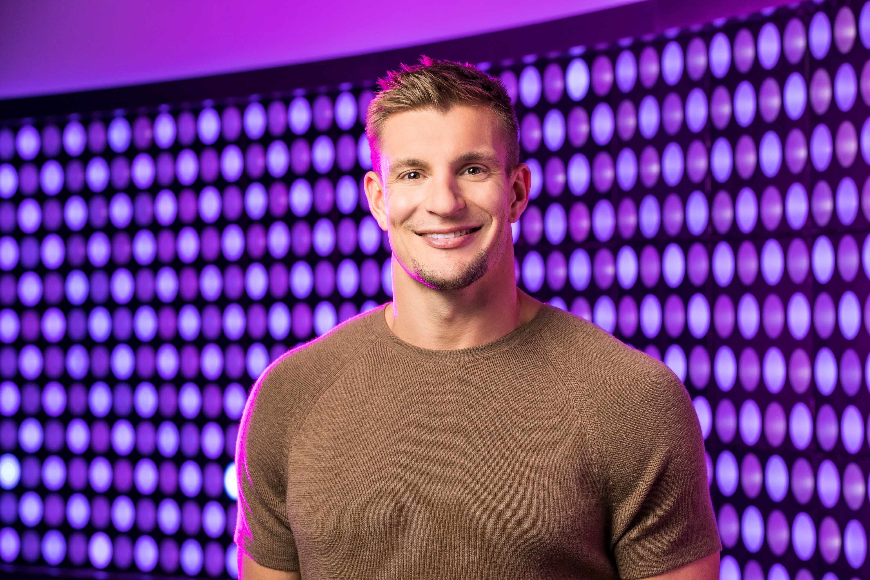 Rob Gronkowski of the show Game On! smiles at the camera.