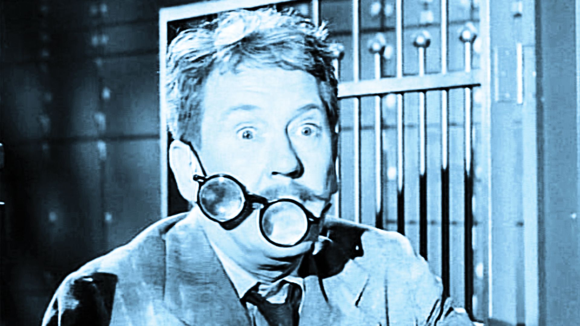 Actor Burgess Meredith with his glasses severely askew in a scene from a classic Twilight Zone.