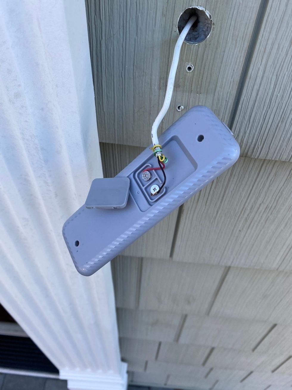 Blue Doorbell Camera mounting bracket connected to doorbell wires.