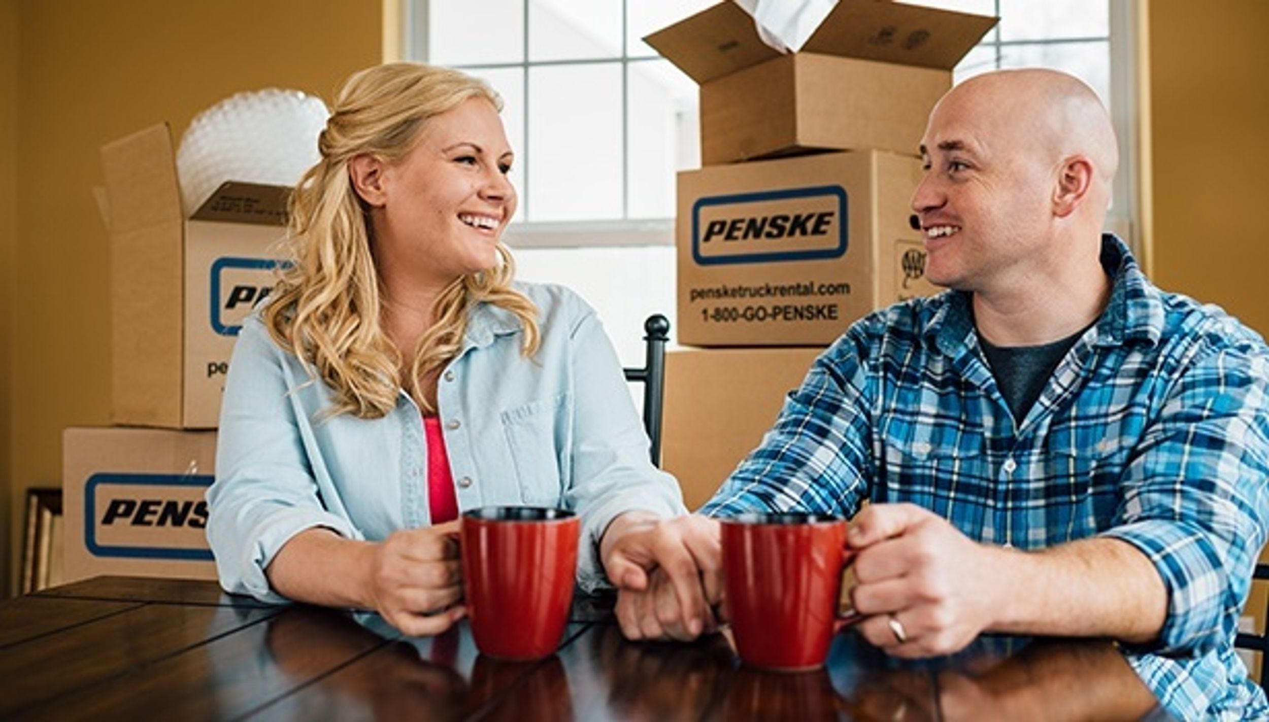 people with penske moving boxes