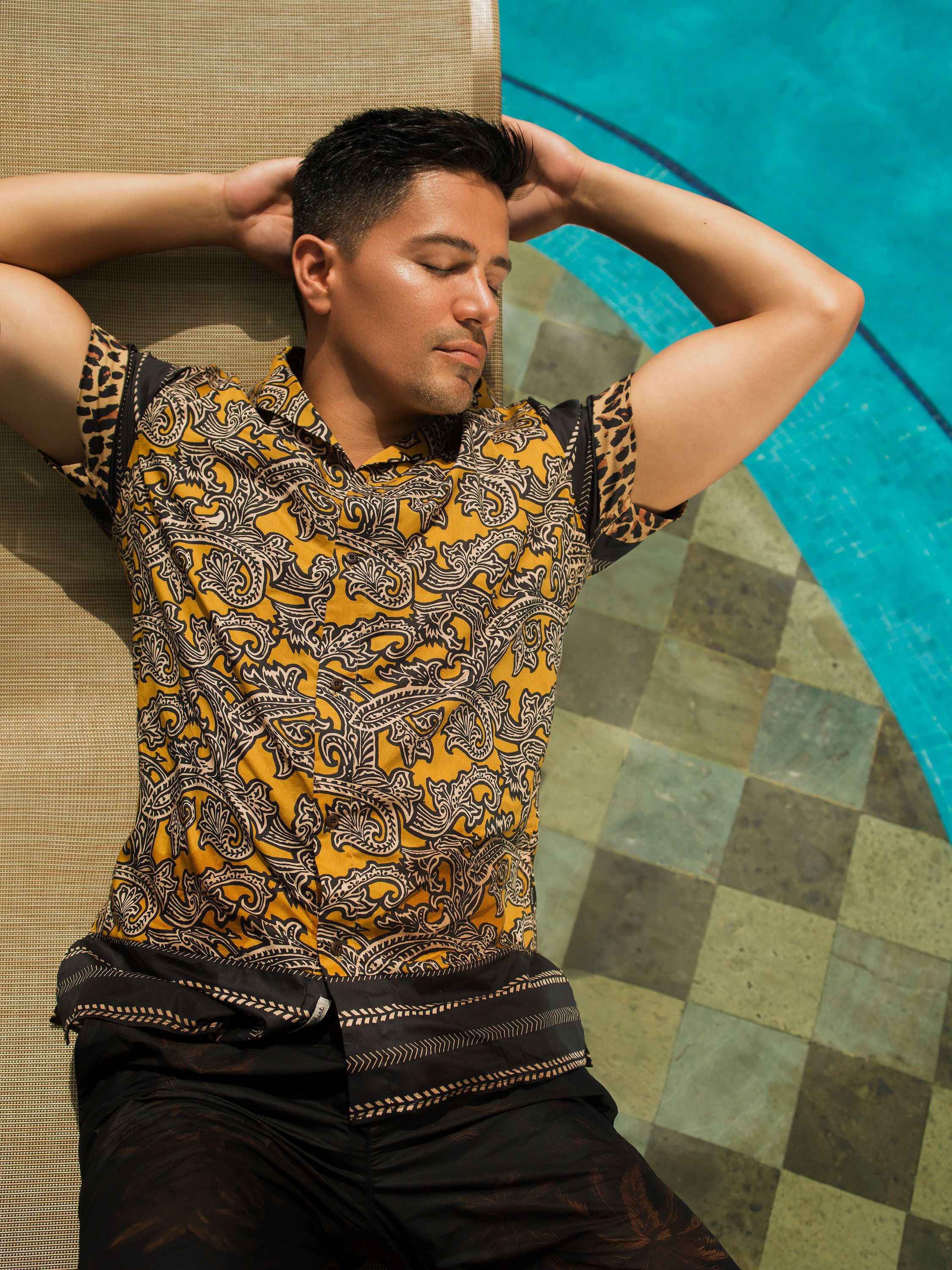 Jay Hernandez naps in the sun while poolside