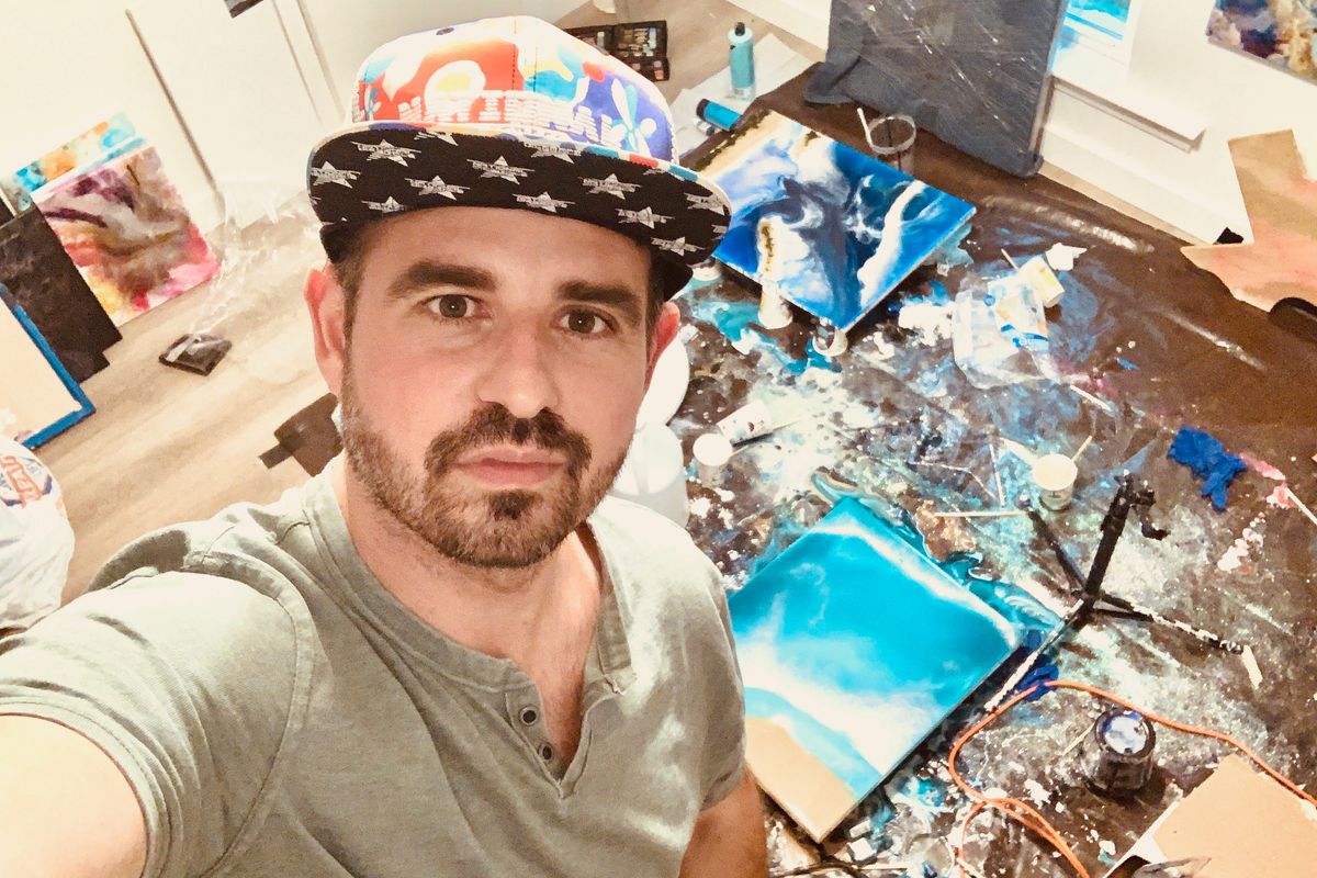selfie of Federico Portalupi with his art in the background