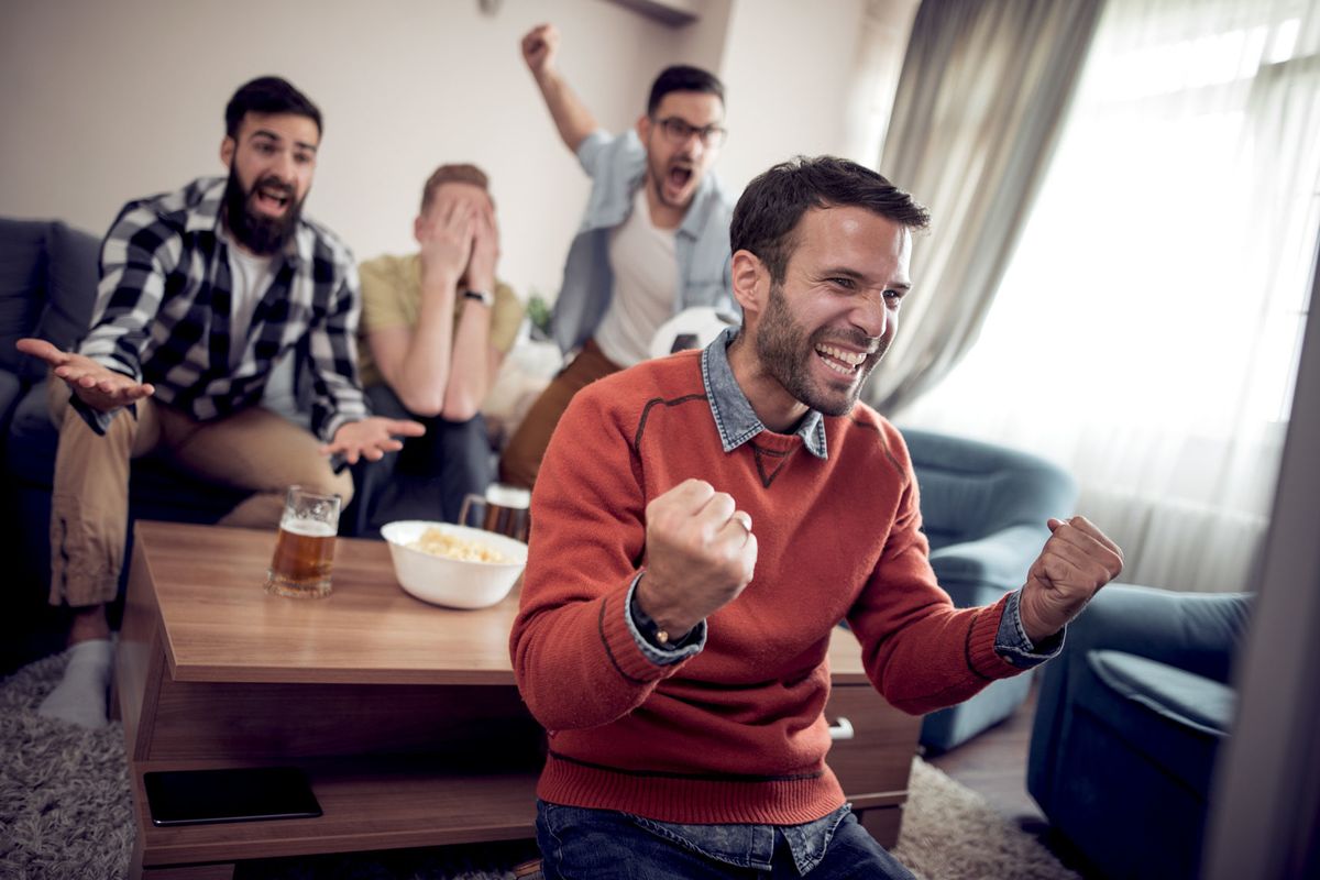 multiple men screaming and laughing at the tv