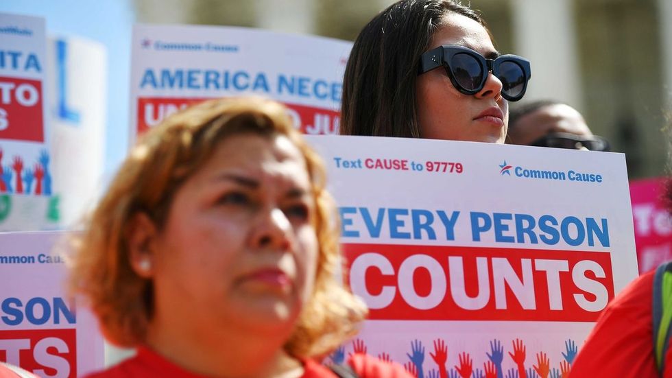 2 women holding signs that say "Every Person Counts"