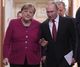 Russian President Vladimir Putin and German Chancellor Angela Merkel arrive for a joint news conference in Moscow