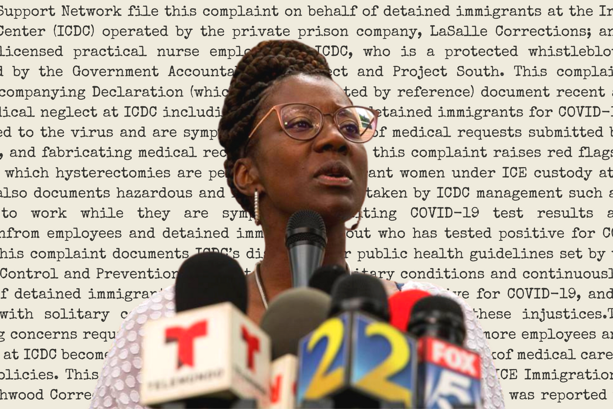 Nurse Dawn Wooten speaking into a group of microphones the background is populated with the words of ler complaint.