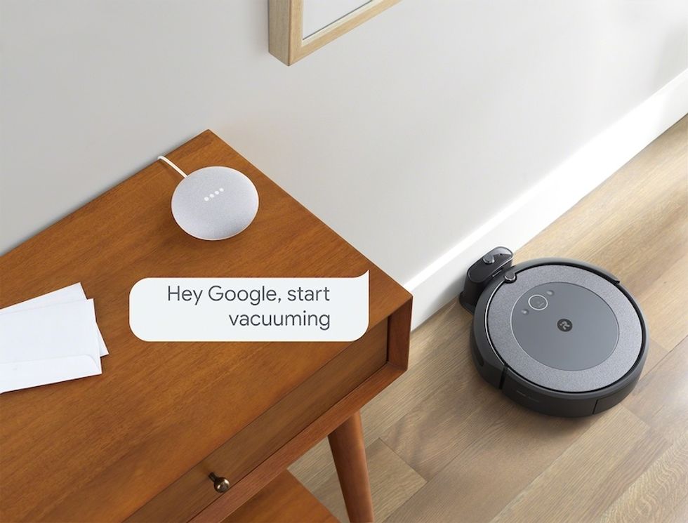 a picture of iRobot i#+ on the floor charging.