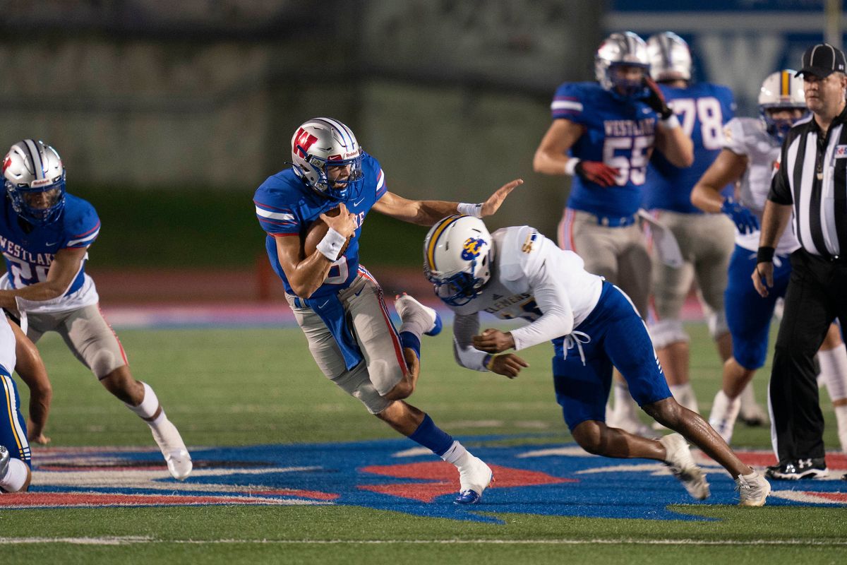 Westlake football players on the field with Clemens players