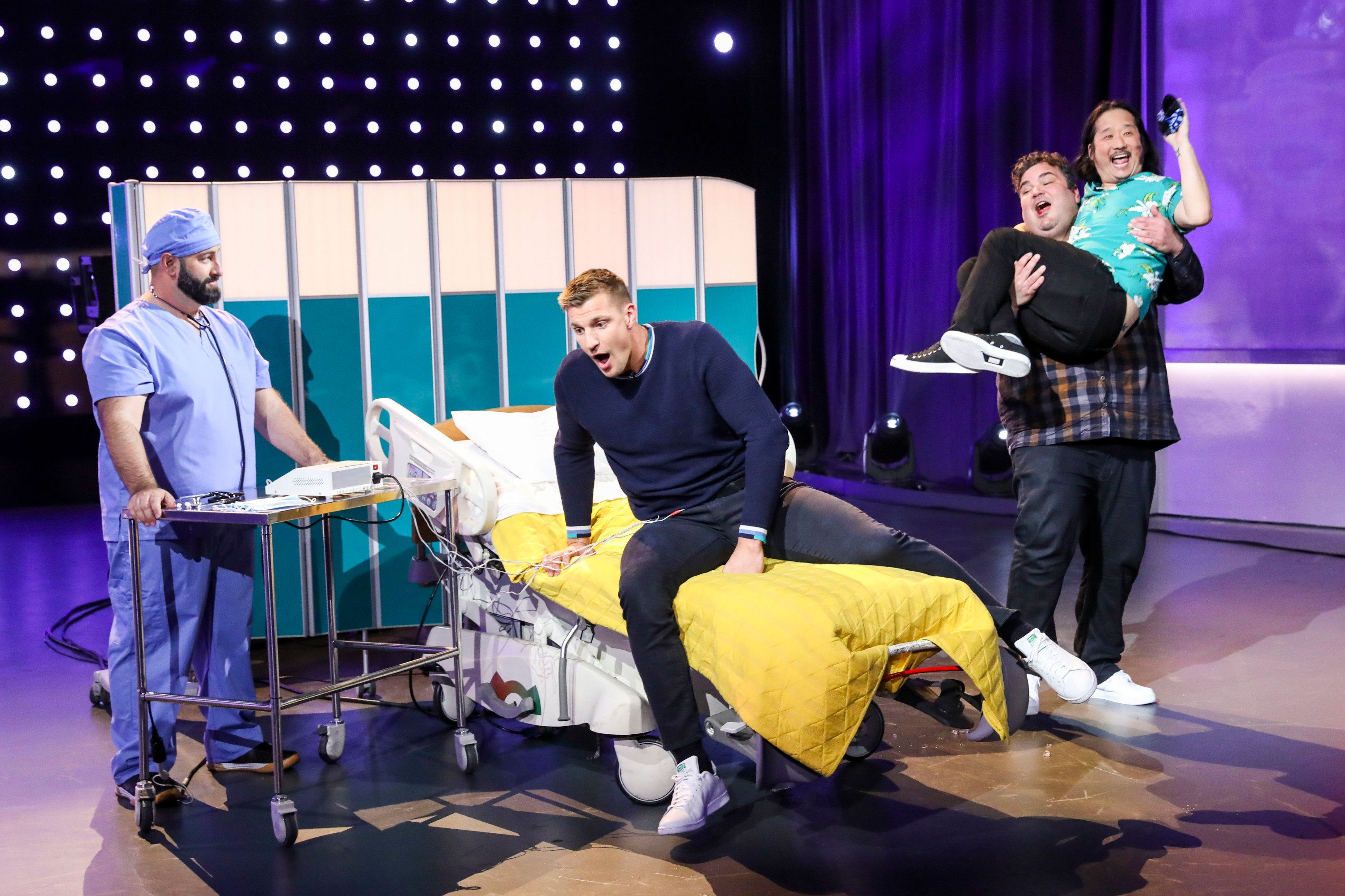 Gronk experiences simulated labor pains with the help of a birthing simulator attached to his abdomen