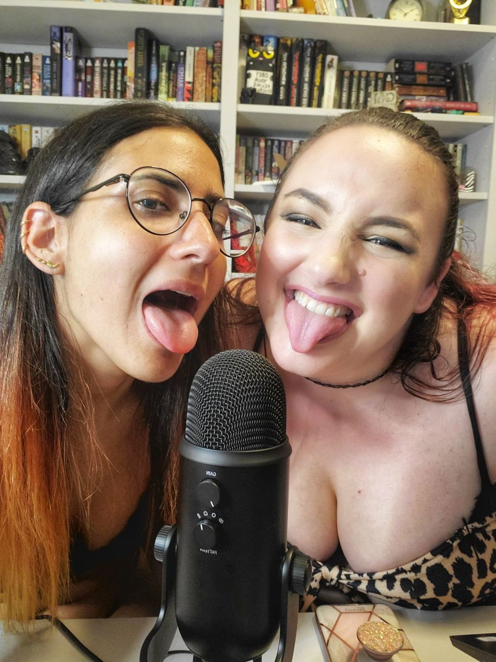 Two women sticking their tongues out while livestreaming