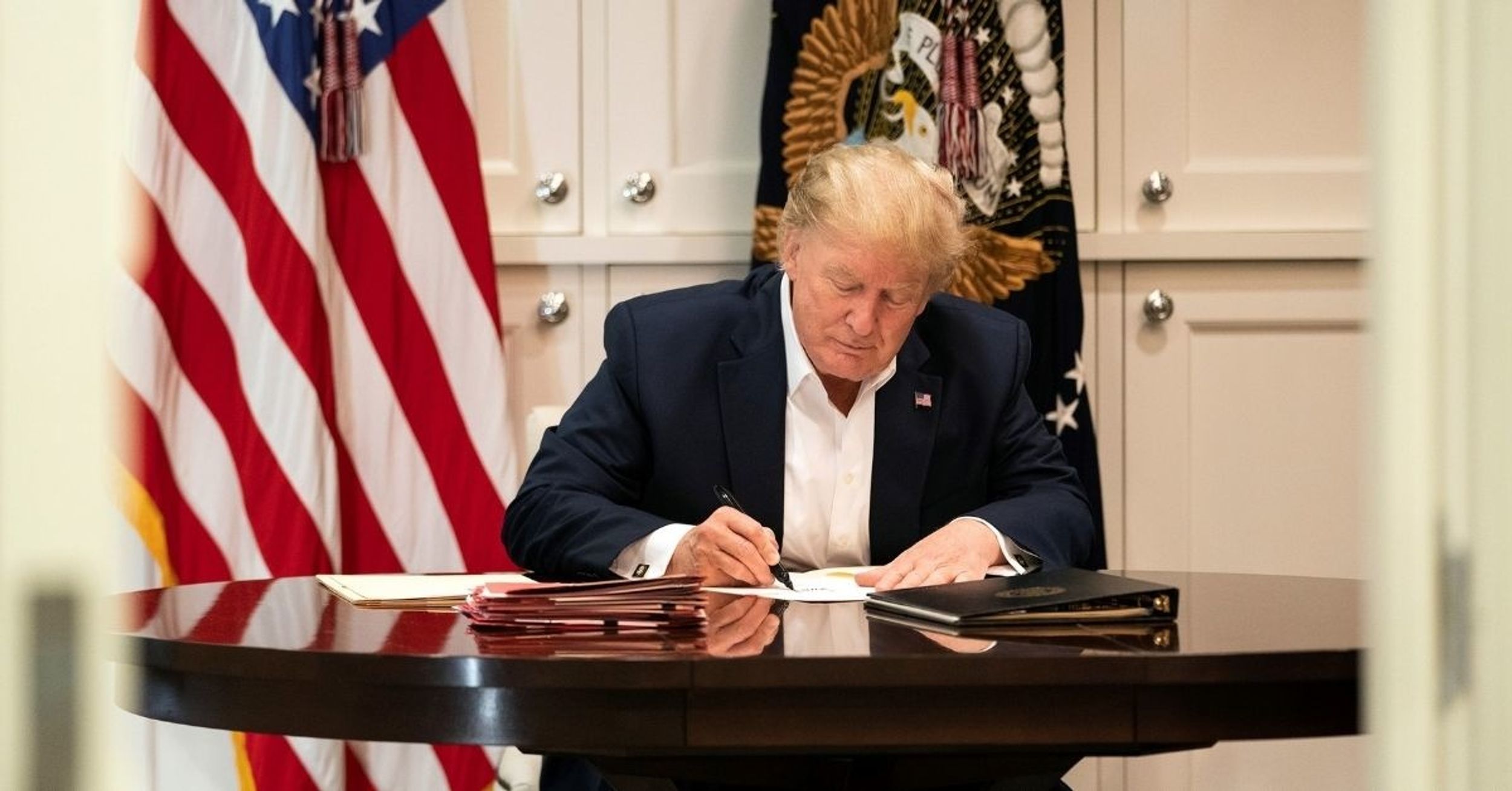 Trump Dragged After Photo Of Him 'Working' At Walter Reed Shows Him Signing A Blank Sheet Of Paper