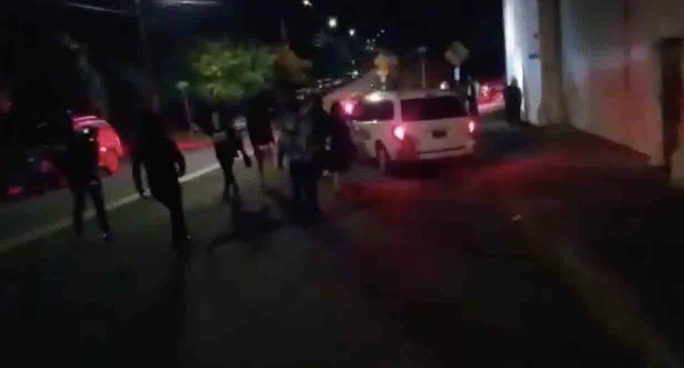 VIDEO: Cop drives motorcycle into protester blocking his path, pushing ...