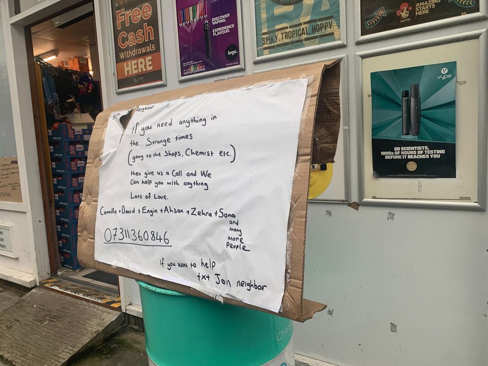 Image of sign asking if anyone needs anything during COVID-19