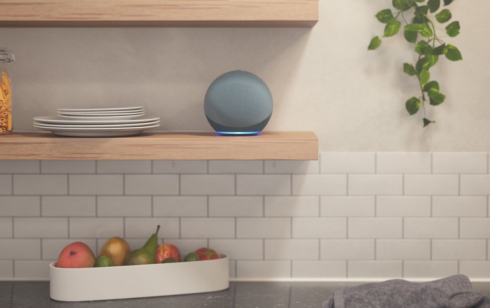 Image of a 2020 Amazon Echo smart speaker in the kitchen on a shelf.