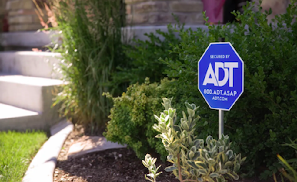 ADT sign on a front lawn
