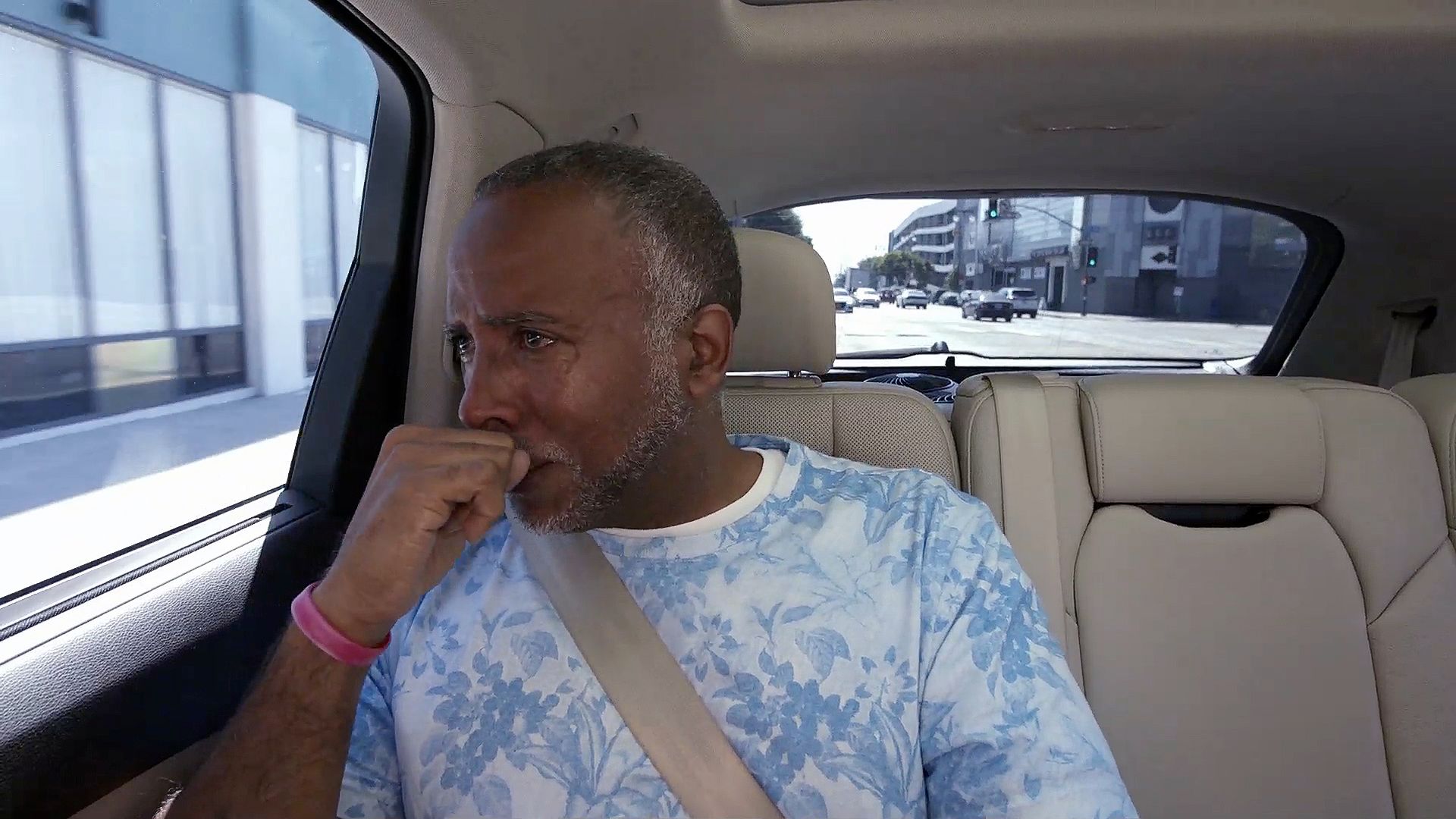 \u200bTearful man in the back seat of the car