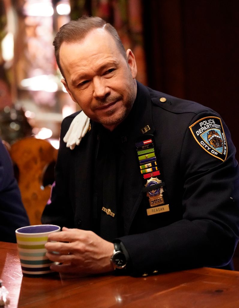 Danny Reagan holding a mug
